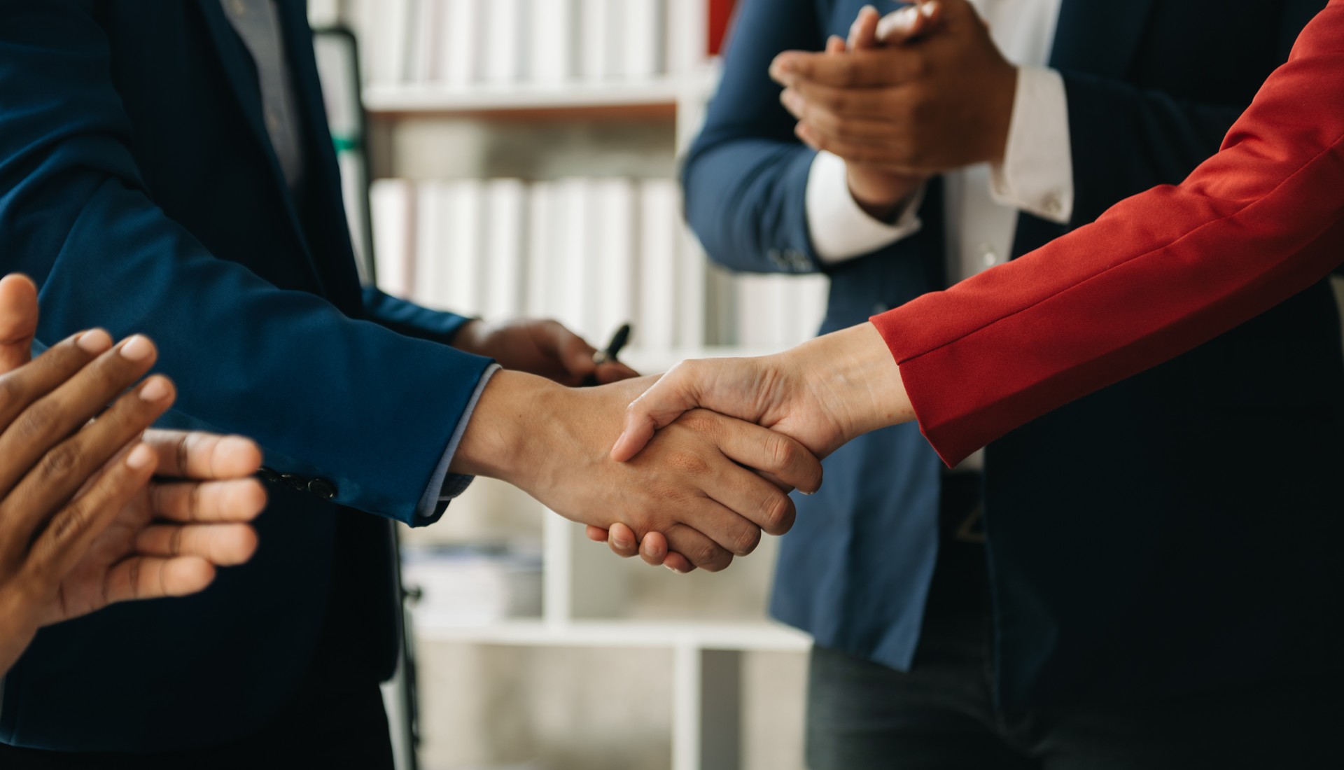business people shaking hands during a meeting in office business people shaking hands during a meeting in office